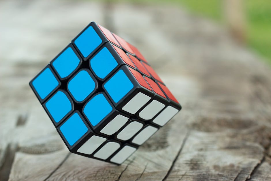 Colorful Rubik's Cube resting on a wooden surface, showcasing vibrant geometric patterns.