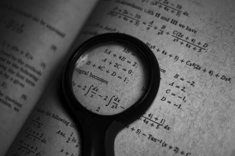 A magnifying glass focuses on mathematics formulas in a book, enhancing study and exploration. Carl Friedrich Gauss